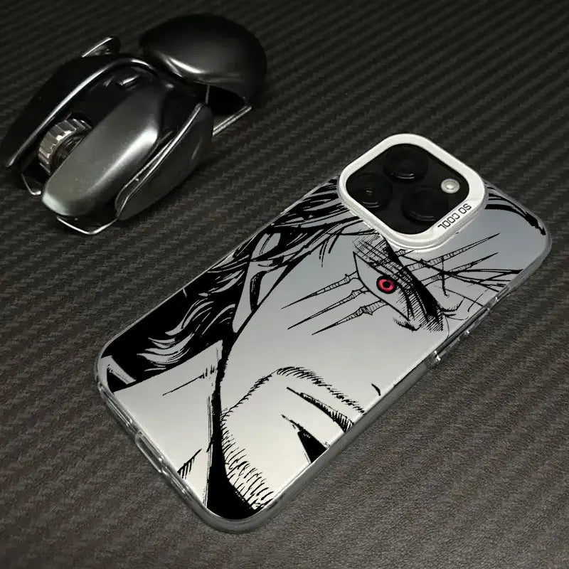 A clear TPU phone case featuring a black and white anime-style illustration of a character's face with a small red eye, shown on a smartphone. The phone case is photographed on a dark gray carbon fiber-textured surface next to a black camera lens.