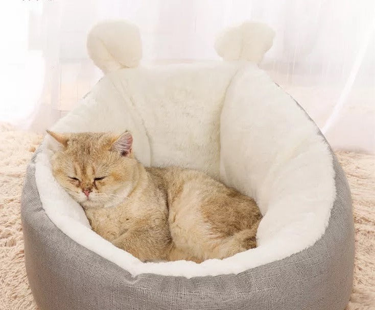 Teal Zeus gray plush pet bed with white faux fur interior and ear accents showing cat sleeping in cat bed sleeping bag