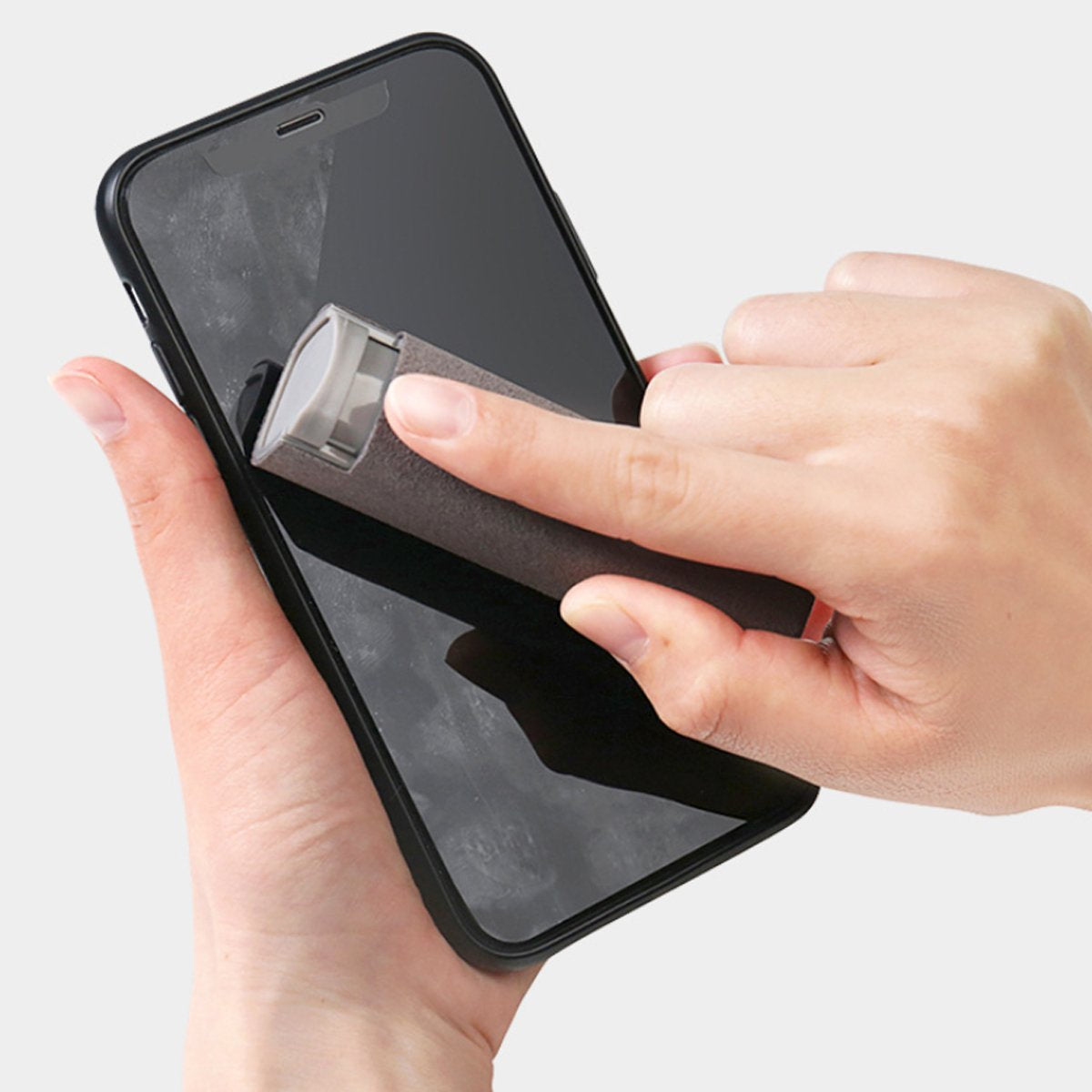 Salmon Lucky phone screen cleaner spray wand removing fingerprints and smudges from smartphone
