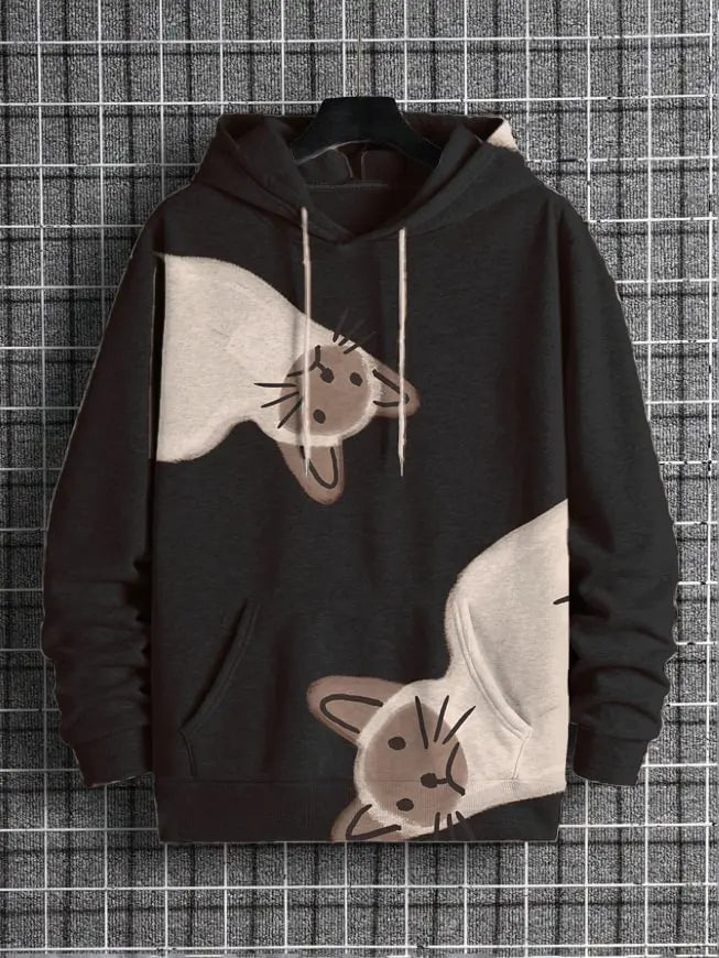 A black pullover hoodie with a graphic print of two upside-down cats in beige and brown, hanging on a black hanger against a gray and white grid background.
