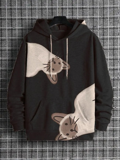 A black pullover hoodie with a graphic print of two upside-down cats in beige and brown, hanging on a black hanger against a gray and white grid background.