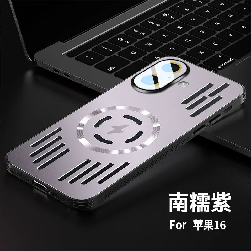 A metallic purple phone case for an iPhone 16, featuring a circular magnetic wireless charging design and horizontal vent slits, shown resting on a dark surface next to a laptop keyboard.