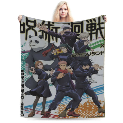 A woman holds up a large printed blanket or towel featuring anime characters from Jujutsu Kaisen and Yu-Gi-Oh! X, including a panda and several fighters in dark uniforms, against a plain white background.
