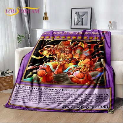 A plush throw blanket featuring a Yu-Gi-Oh! character design, draped over a white sofa in a living room setting. The blanket has a purple border with card-style text and a central illustration of a fiery orange dragon-like creature.