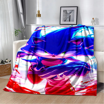 A colorful throw blanket featuring Sonic the Hedgehog artwork, draped over a white sofa in a modern living room setting.