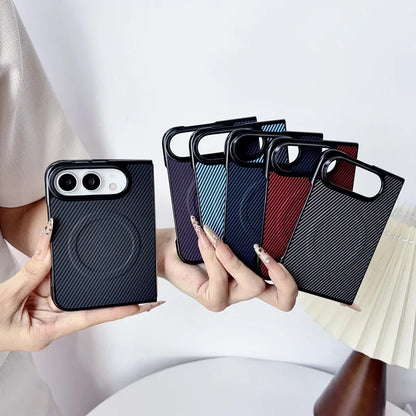 A person holds several slim phone cases with a circular magnetic ring design. The front case is black with a carbon-fiber-style texture, and the cases behind it show additional color options including dark blue, light blue, dark red, and dark gray with diagonal stripes.