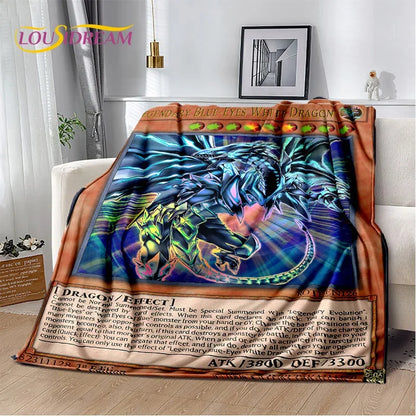 A colorful throw blanket featuring a dramatic illustration of a blue dragon with glowing eyes and a gold border, styled draped over a white sofa in a modern living room setting.