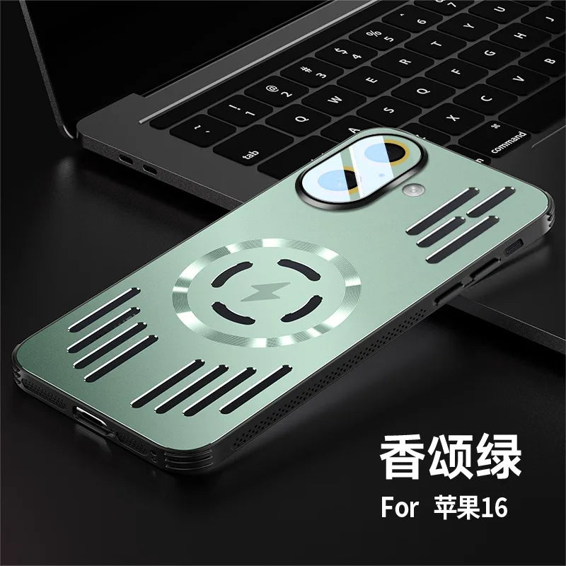 A sage green metallic magnetic phone case for iPhone 16, shown resting on a black laptop keyboard. The case features a circular magnetic center with a lightning bolt symbol, ventilation slots, and a camera cutout with a reflective lens protector.