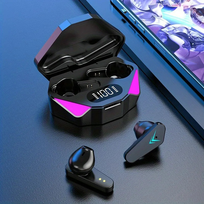 Black wireless earbuds with charging case on a blue surface, next to a smartphone displaying a game.