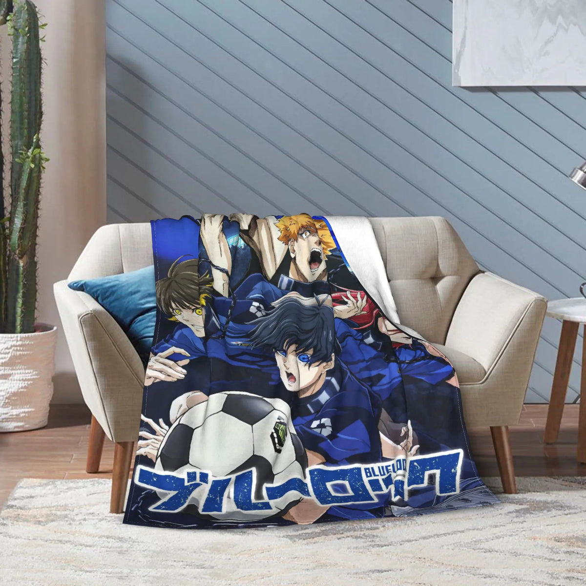 A printed throw blanket featuring anime characters from Blue Lock, draped over a beige armchair in a modern living room setting.