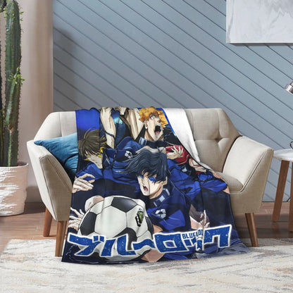 A printed throw blanket featuring anime characters from Blue Lock, draped over a beige armchair in a modern living room setting.