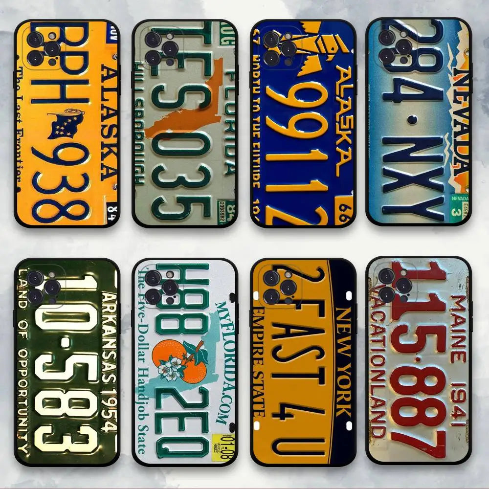 Eight phone cases designed to look like vintage US license plates, arranged in a 2x4 grid on a light marble background. The designs include states such as Alaska, Florida, Nevada, Arizona, New York, Maine, and others, featuring colorful retro patterns and text.