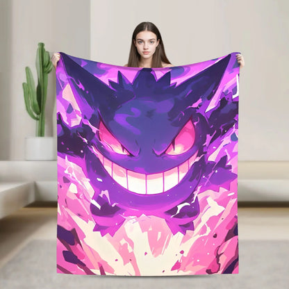 A woman holds up a large blanket featuring a colorful anime-style Gengar design in shades of purple and pink, set against a modern, minimalist living room background.