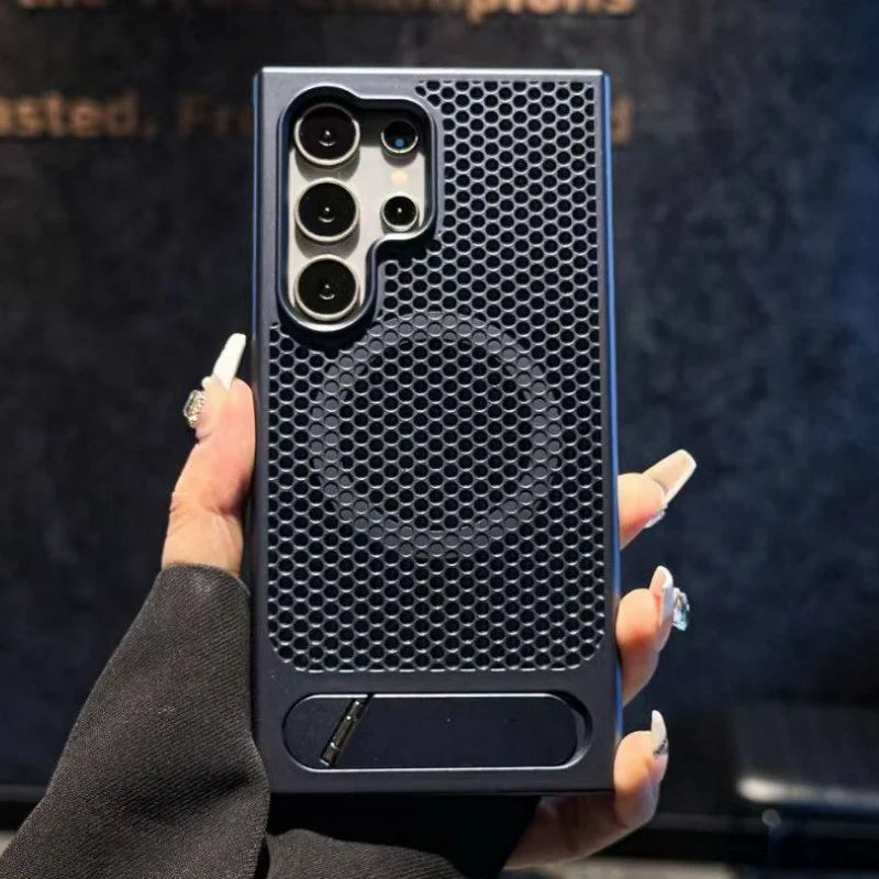 Person holding a black honeycomb-patterned phone case against a dark background