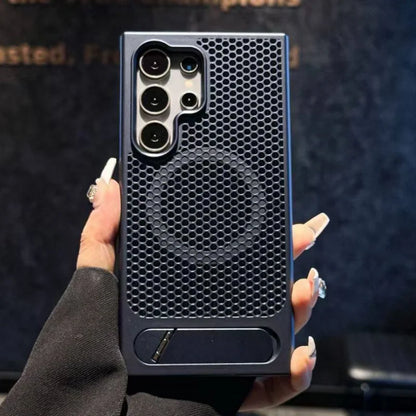 Person holding a black honeycomb-patterned phone case against a dark background
