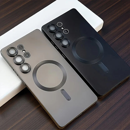 Two smartphones, one black and one silver, on a wooden surface.