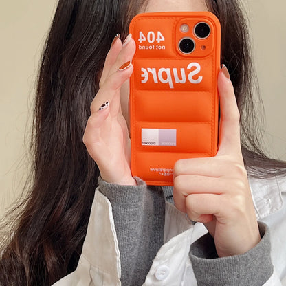 Person holding an orange phone case with 'Supreme' branding