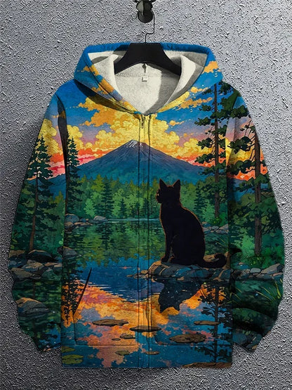 Hoodie with a nature-themed design of a lake and mountains on a hanger against a gray wall.