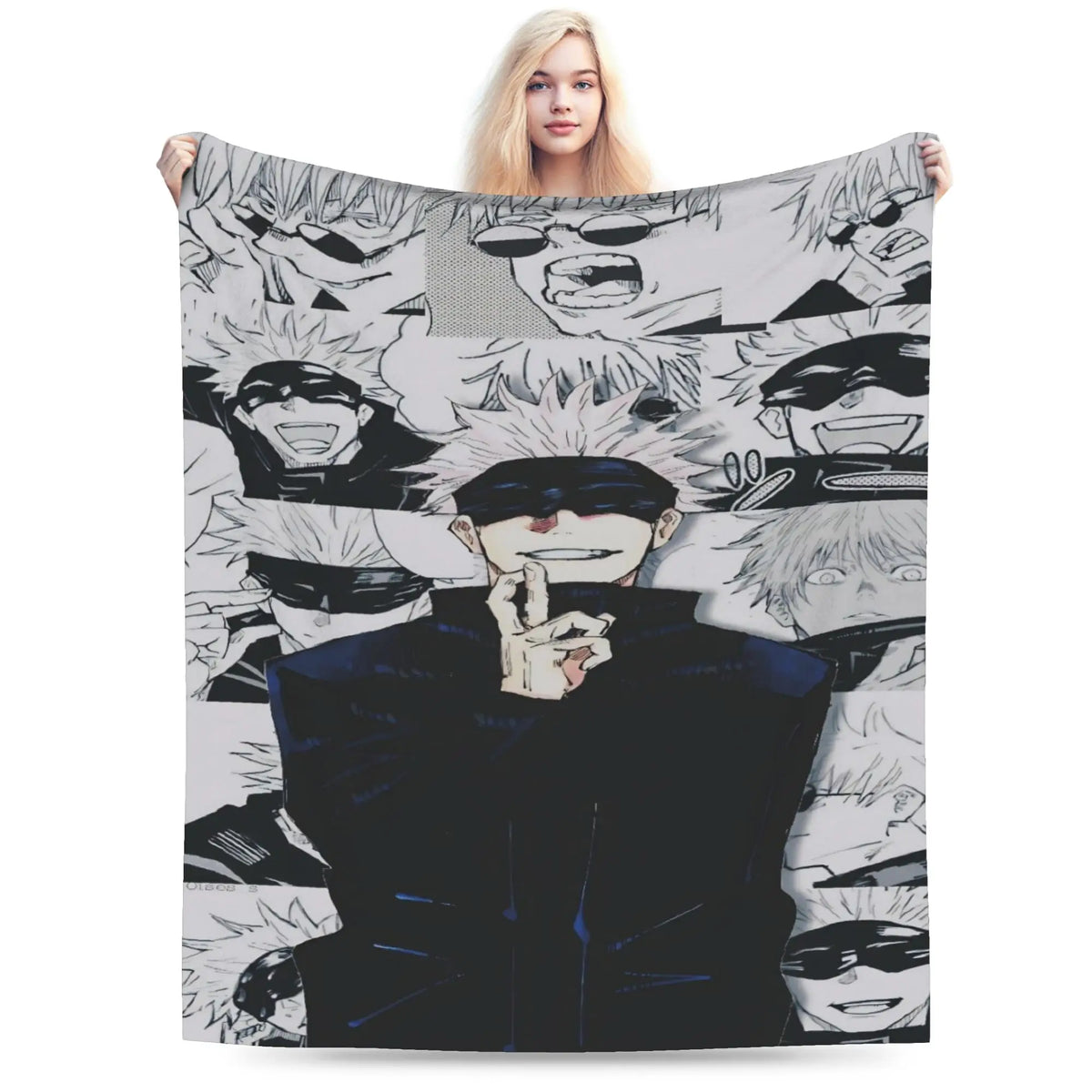 A woman holds up a large blanket featuring a collage of black and white anime character faces, with one central figure in a dark blue outfit and black mask. The background is solid white.