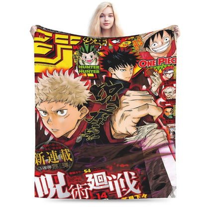 A woman holds up a large printed blanket or throw featuring anime-style characters and bold Japanese text. The blanket has a busy collage design with multiple characters, including One Piece and Hunter x Hunter, in red, black, yellow, beige, and white tones.