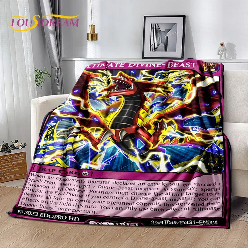 A colorful plush blanket featuring a vibrant Yu-Gi-Oh! Cobra Battle card design, draped over a white sofa in a living room setting.