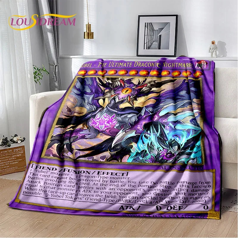A colorful fantasy dragon-themed blanket draped over a white sofa in a living room setting. The blanket features a purple border, detailed dragon artwork in black, purple, blue, and gold, and a card-style text section at the bottom resembling a trading card.