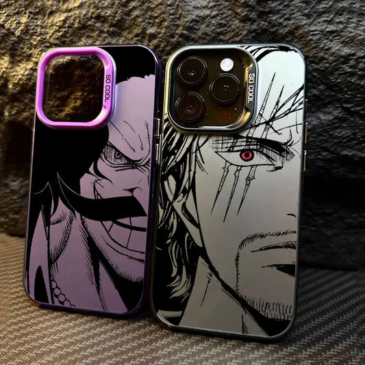 Two anime phone cases featuring characters from One Piece, displayed side-by-side on a textured gray surface with a dark stone background. The left case has a black and purple design with a purple camera bumper, and the right case has a black and silver design with a gold camera bumper.