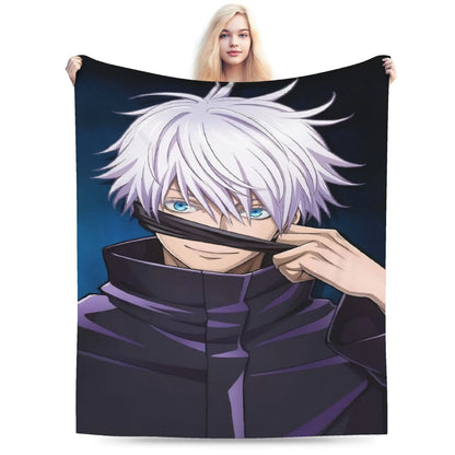 A person holding up a large printed blanket or tapestry featuring an anime-style character with silver hair and blue eyes, wearing a dark purple high-collar outfit against a dark blue background. The person is partially visible behind the blanket, which fills most of the frame.