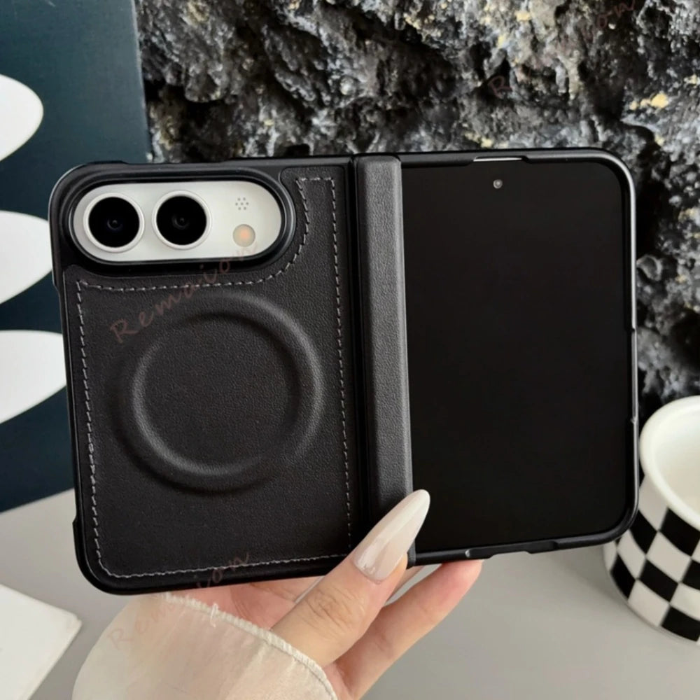 A black phone case with a built-in card slot and magnetic ring, held in a hand against a dark textured background.
