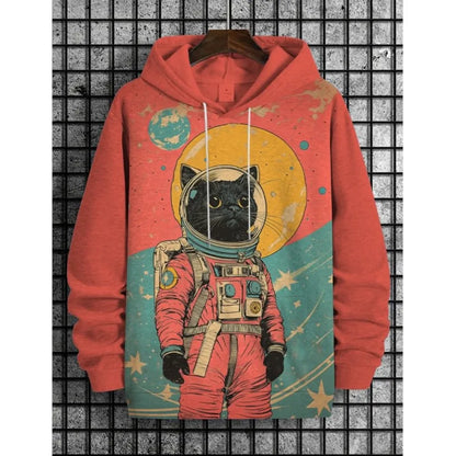 A coral red pullover hoodie with a graphic print of a black cat dressed as an astronaut, hanging on a wooden hanger against a gray grid background.