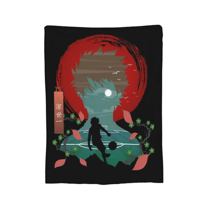 A rectangular black wall tapestry or blanket featuring a stylized graphic illustration of a soccer player silhouette in front of a large red circular motif, with teal sky, moon, birds, cherry blossoms, and a hanging vertical tag with Japanese characters.