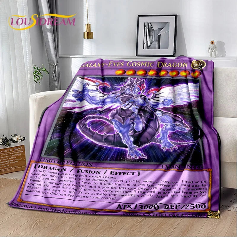 A plush throw blanket featuring a purple and blue 'Galaxy-Eyes Cosmic Dragon' anime-style illustration, styled draped over a white sofa in a living room setting.