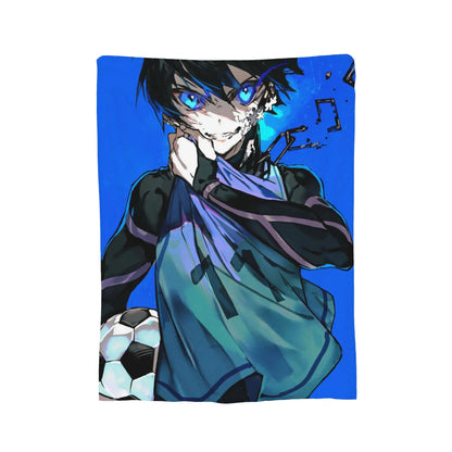 A rectangular printed blanket or towel featuring anime-style artwork of a character with blue eyes, dark hair, a torn face effect, and a soccer ball on a bright blue background, shown on a plain white studio backdrop.