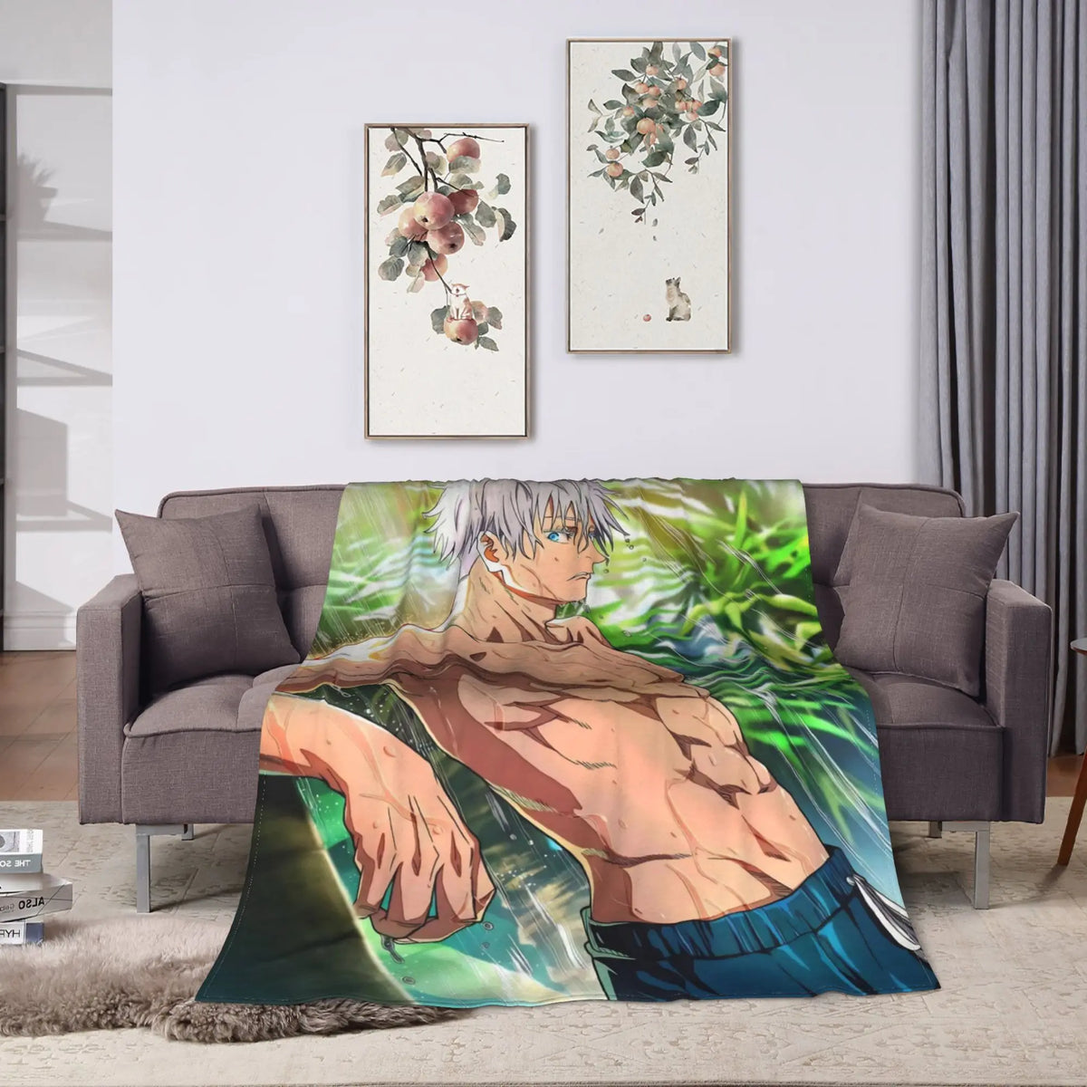 A printed anime-style throw blanket draped over a gray sofa in a living room setting. The blanket features a shirtless male character with silver hair and blue shorts against a green background.