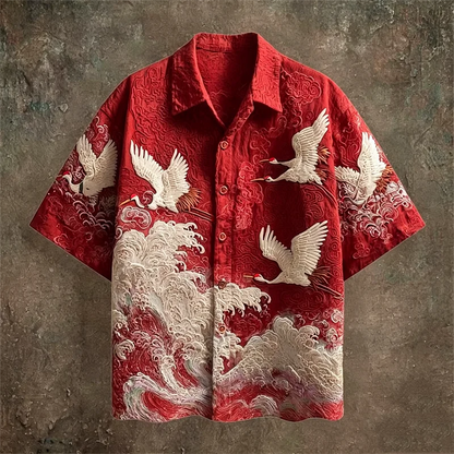 Red shirt with white crane and wave patterns on a textured brown background