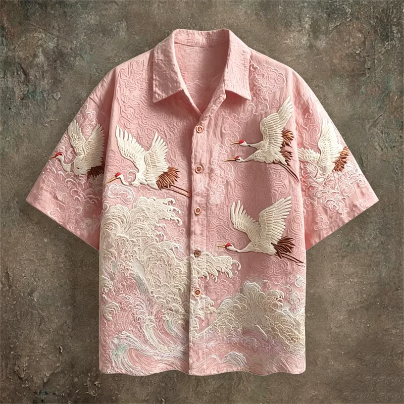 Pink shirt with crane embroidery on a textured brown background