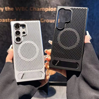 Two phone cases, one silver and one black, held by a person against a blurred background.
