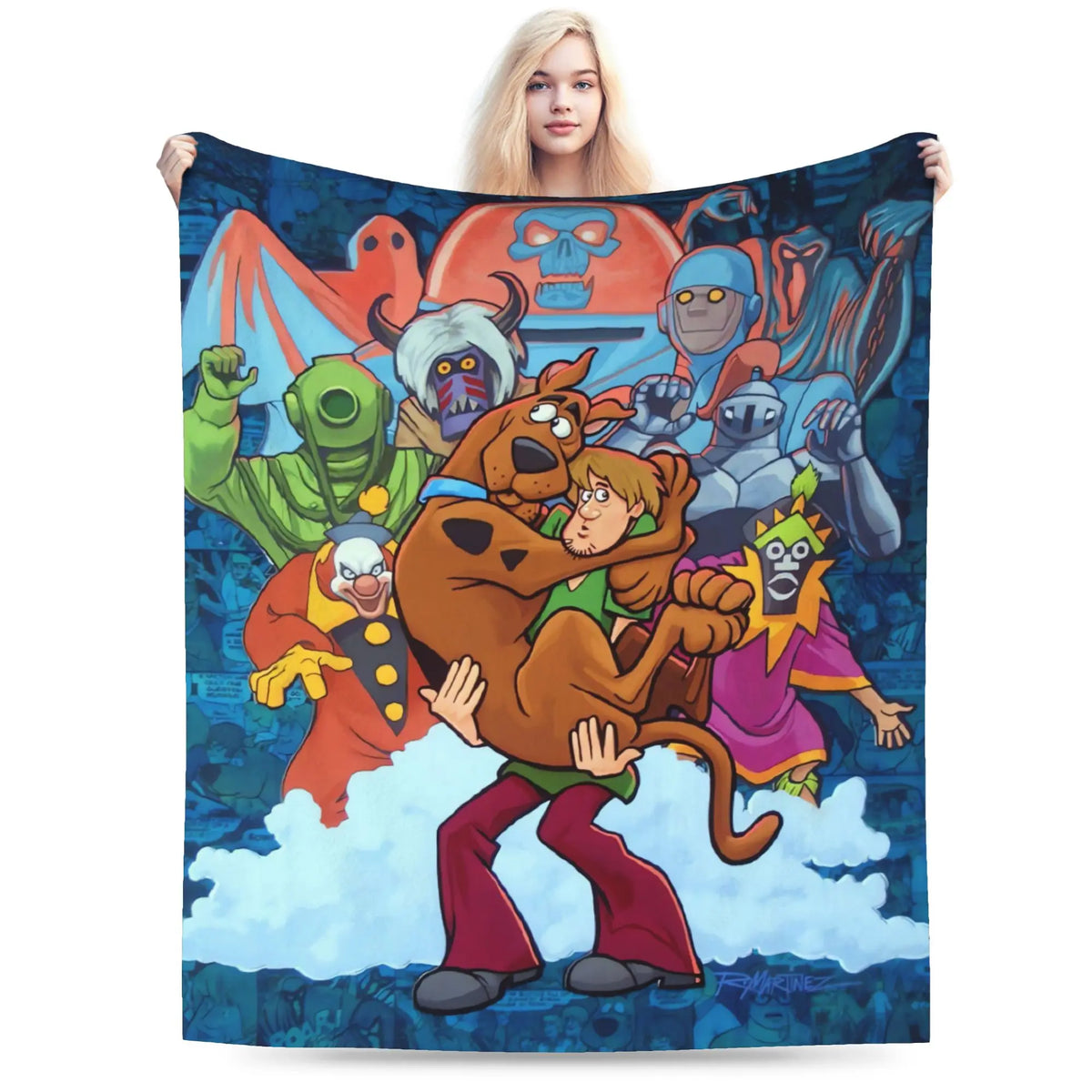 A woman holds up a large printed blanket or tapestry featuring the Scooby-Doo cartoon characters against a dark blue background. The blanket shows Scooby, Shag, and other classic villains in colorful artwork, and the model is standing behind it against a plain white studio background.