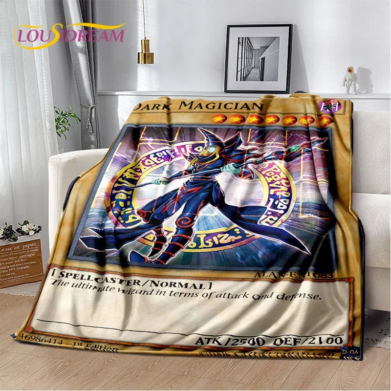 A plush throw blanket featuring Yu-Gi-Oh! Dark Magician card art, draped over a white sofa in a modern living room setting.