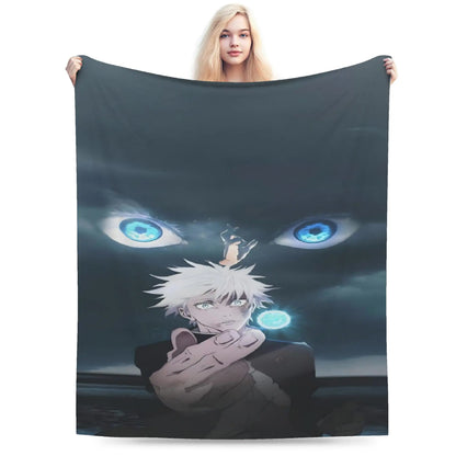 A woman holds up a large dark gray blanket or tapestry featuring an anime-style illustration of a white-haired character with glowing blue eyes and a small figure on his head, shown against a plain white background.