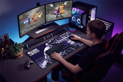 Person playing a video game on a computer setup with multiple monitors and gaming accessories.