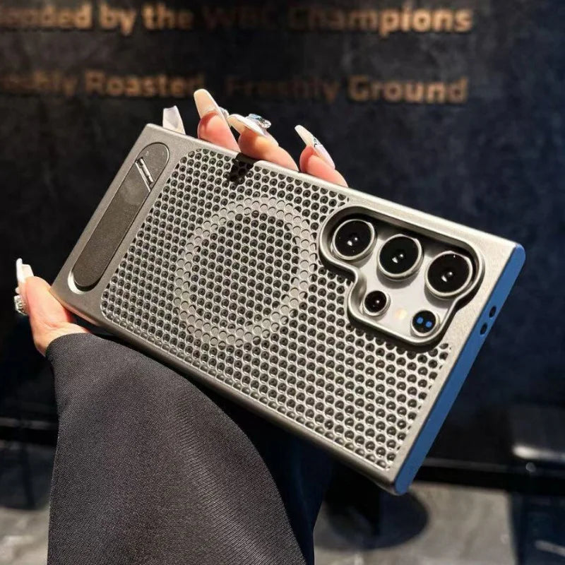 Person holding a phone case with a unique design against a dark background