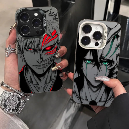 Two anime-style phone cases held in hands, featuring black-and-gray character portraits with red and green eye accents. The left case has a black camera surround and the right case has a silver camera surround.