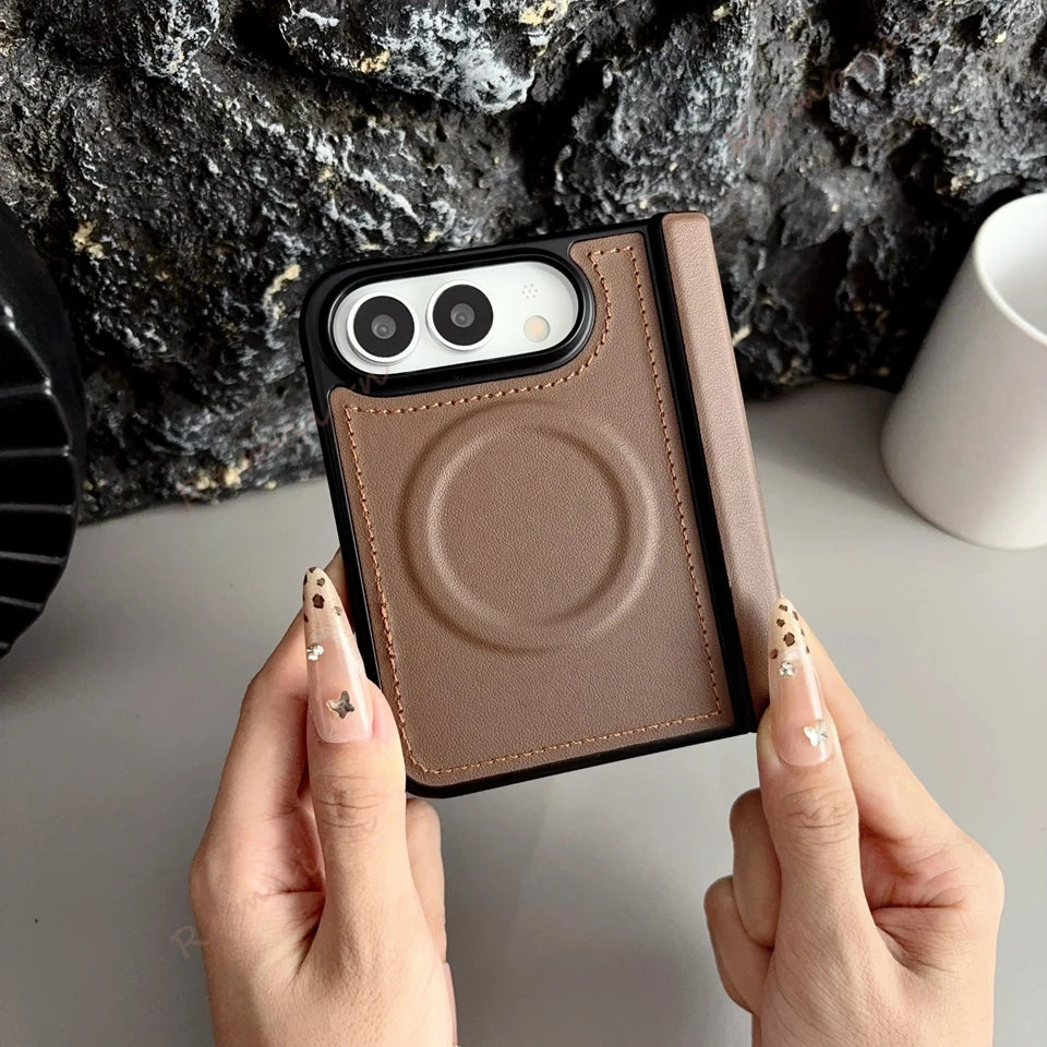 A person holds a slim brown leather magnetic card case phone case with a black bumper. The case features a circular MagSafe-compatible magnetic ring on the back and a matching brown leather card slot on the side.