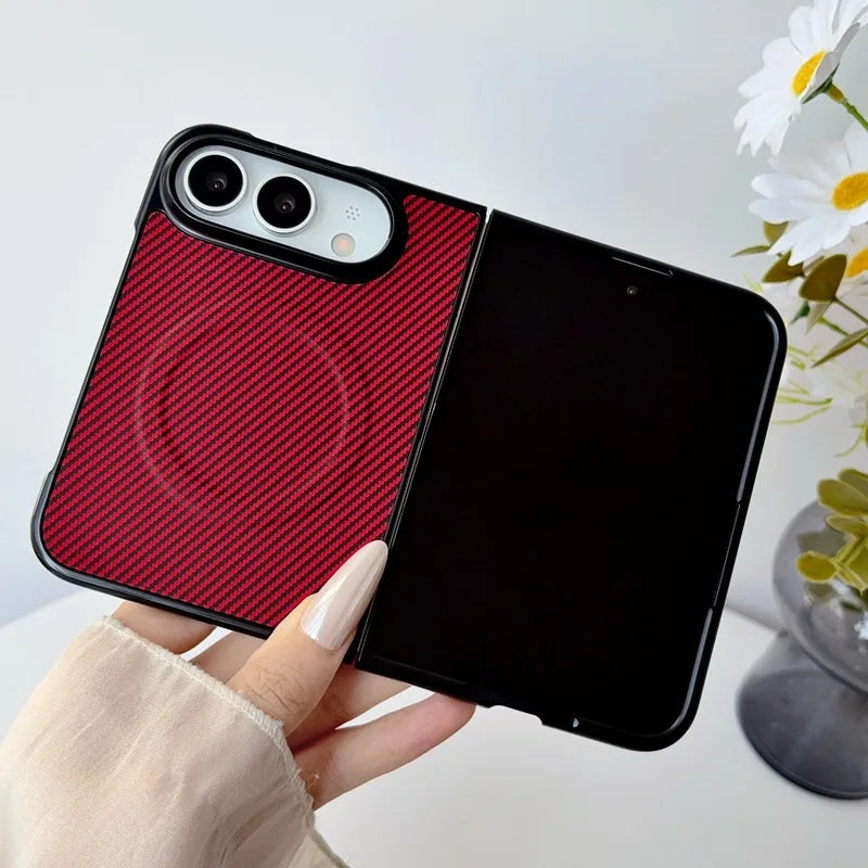 A hand holds a black smartphone case with a split design: one half is textured red, and the other half is black. The phone inside is black and turned off.