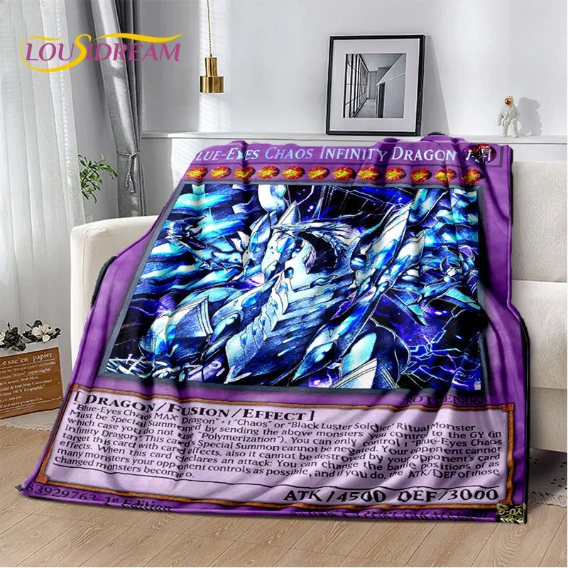 A plush throw blanket featuring Yu-Gi-Oh! artwork of Blue-Eyes Chaos Infinity Dragon, styled draped over a white armchair in a modern living room setting.