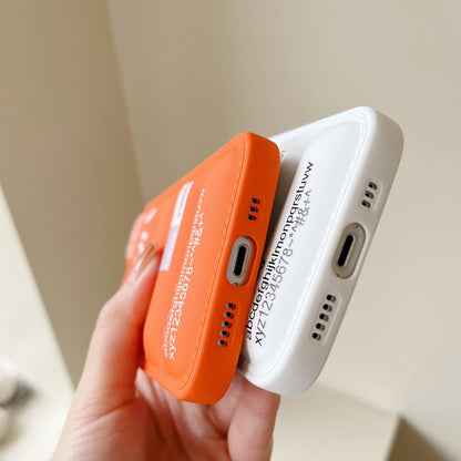 Two small electronic devices, one orange and one white, held by a hand against a neutral background.
