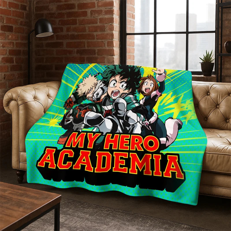 A colorful blanket featuring My Hero Academia anime characters and the title 'MY HERO ACADEMIA' draped over a tan leather sofa in a living room setting.