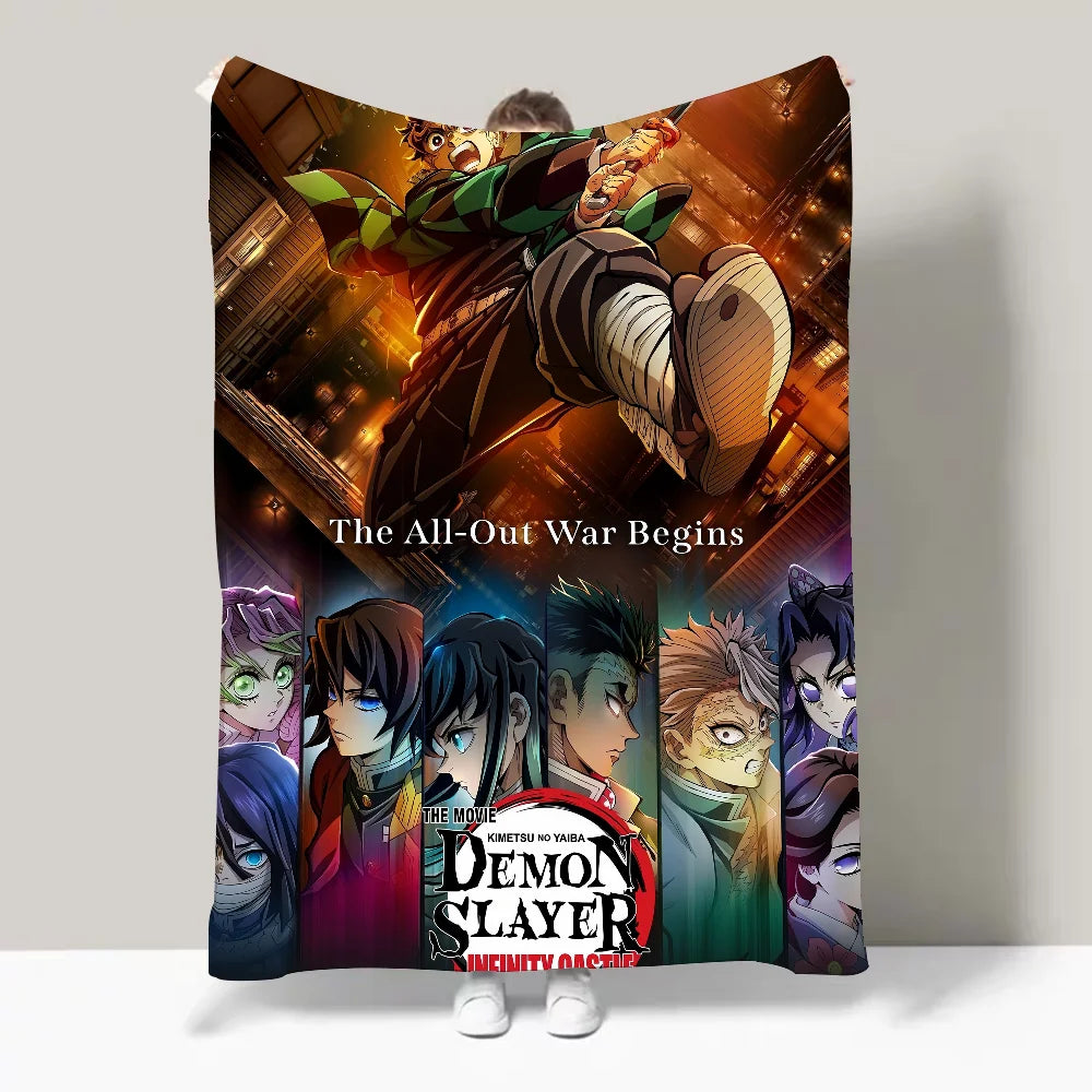A person holds up a large blanket or poster featuring the Demon Slayer: Infinity Castle anime artwork, with the text 'The All-Out War Begins' and character portraits along the bottom. The scene is photographed against a plain light gray wall.