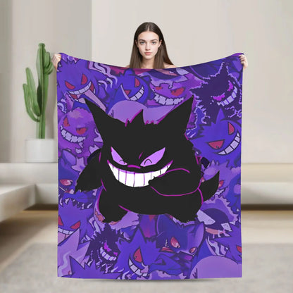 A woman holds up a large blanket featuring a repeating purple and black Gengar pattern, set against a modern, minimalist beige interior background.